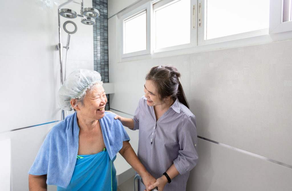 Nurse helping senior women with bathing