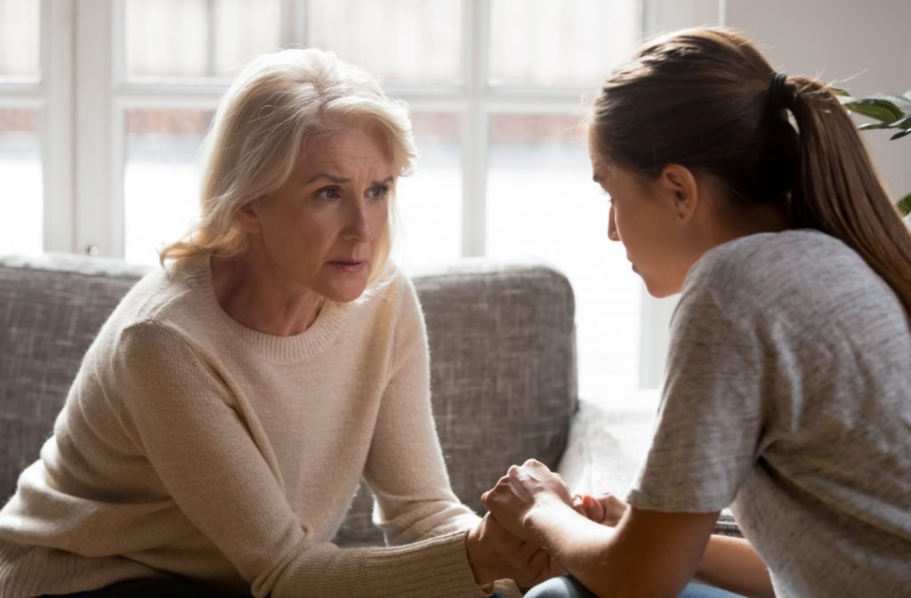 An adult child has a serious and open conversation with their loved one around moving to assisted living.