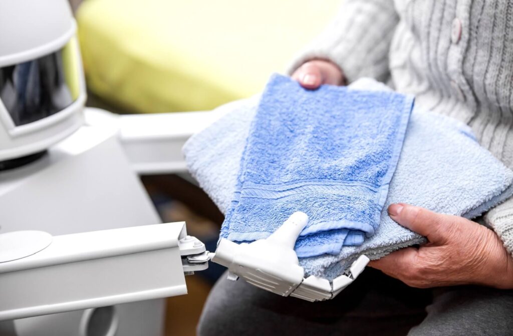 a robot helping a senior bringing their towels