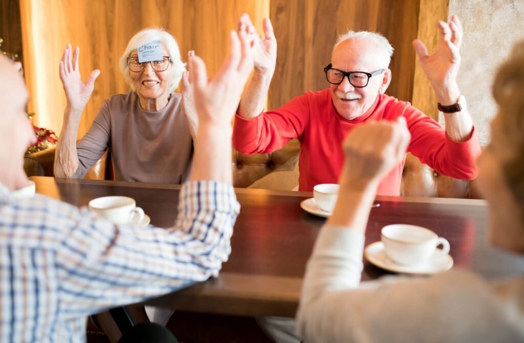A group of seniors celebrate upon one of them successfully guessing the word on their forehead